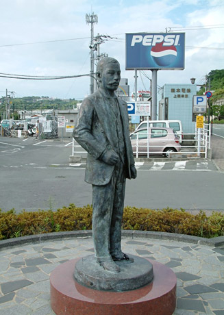 元の夏目漱石像。後ろは今もある熊本電気鉄道 上熊本駅